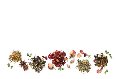 Different dry herbal teas on white background, top view