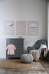 Baby room interior with cute posters and rocking chair