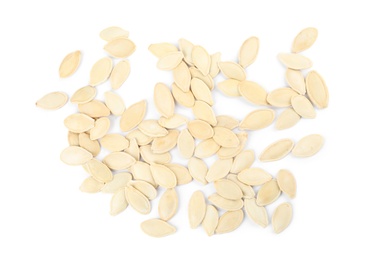 Raw unpeeled pumpkin seeds on white background, top view