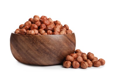 Bowl with tasty organic hazelnuts on white background