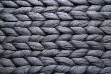 Black knitted wool texture as background, top view