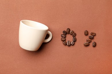 0 percent made of coffee beans and cup on color background, flat lay. Decaffeinated drink