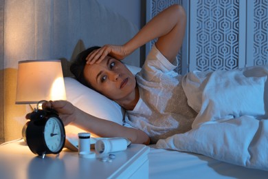 Mature woman suffering from insomnia in bed at night