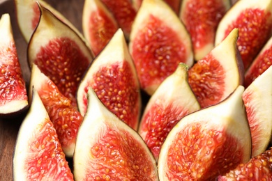 Slices of tasty fresh figs as background, closeup