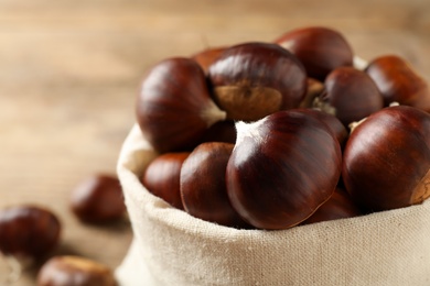 Fresh sweet edible chestnuts in sack, closeup