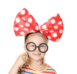 Little girl with large bow and funny glasses on white background. April fool's day