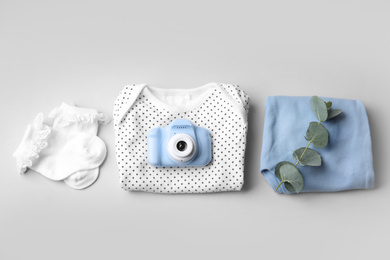 Flat lay composition with toy camera on light grey background. Future photographer