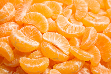 Fresh juicy tangerine segments as background, closeup