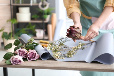 Female florist creating bouquet at workplace