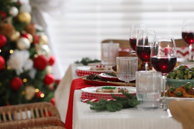 Festive dinner with delicious gingerbread cookie and wine on table indoors, space for text. Christmas Eve celebration