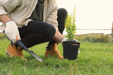Photo of Man planting tree in countryside, closeup view