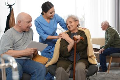 Nurse taking care of elderly patients in geriatric hospice