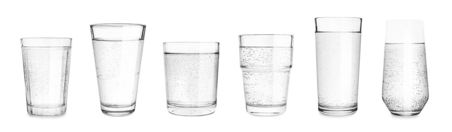 Set with different glasses of soda water on white background. Banner design