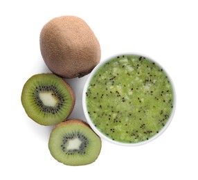Kiwi puree in bowl and fresh fruits on white background, top view