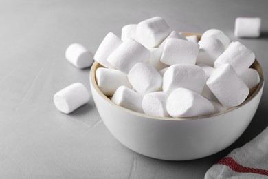 Delicious puffy marshmallows on grey table, closeup