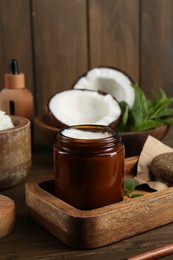 Photo of Homemade cosmetic product and fresh ingredients on wooden table