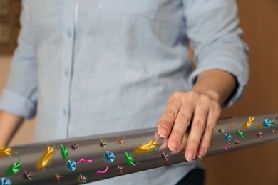 Image of Woman leaning on metal railing full of microbes indoors, closeup