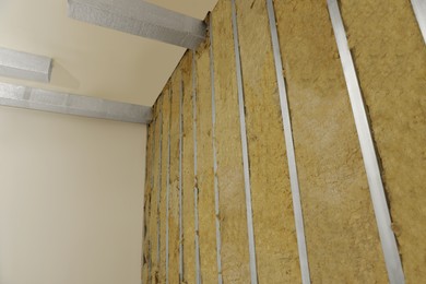 Wall with metal studs and insulation material indoors