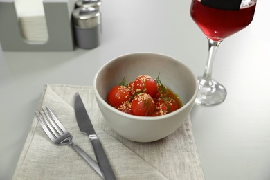 Photo of Tasty soup with blanched tomatoes and beer on light table