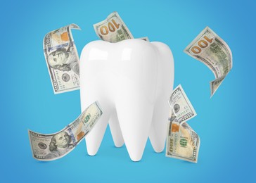 Model of tooth with dollar banknotes on turquoise background. Concept of expensive dental procedures