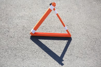 Photo of Triangular parking barrier on asphalt road outdoors