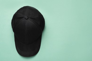 Baseball cap on light background, top view. Space for text