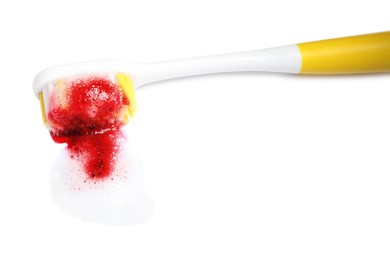 Toothbrush with paste and blood on white background. Gum inflammation