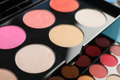 Photo of Beautiful palette of colorful eyeshadows as background, closeup