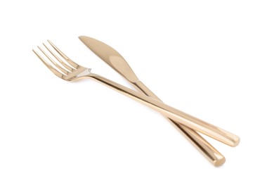 New shiny golden fork and knife on white background
