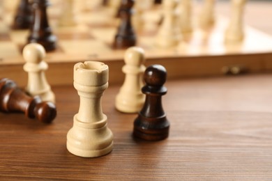 Closeup view of chess pieces on wooden table, space for text. Board game