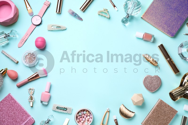 Frame of cosmetic products and accessories on light blue background, flat lay. Space for text