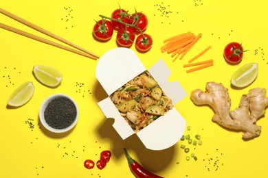Flat lay composition with noodle wok and ingredients on yellow background