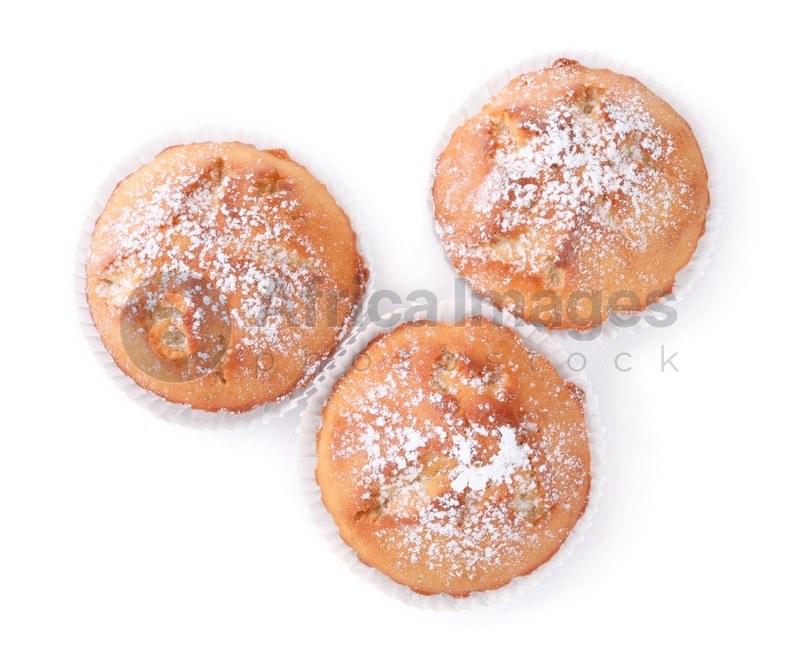Photo of Tasty muffins powdered with sugar on white background, top view