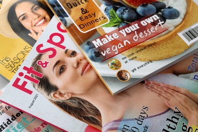 Variety of women's modern magazines, closeup view