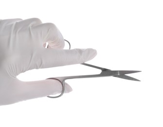 Doctor holding surgical scissors on white background, closeup. Medical instrument