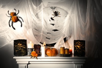 Different Halloween decor on fireplace indoors. Festive interior