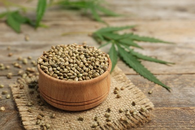 Bowl of hemp seeds on wooden table