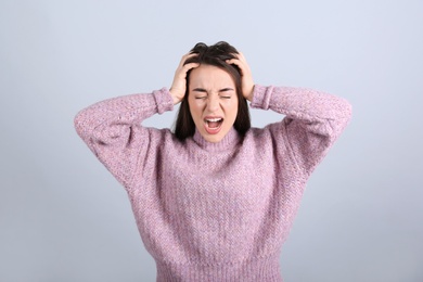 Photo of Portrait of stressed young woman on grey background