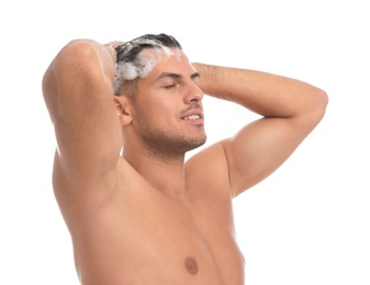 Handsome man washing hair on white background