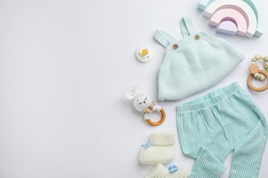 Photo of Flat lay composition with baby clothes and accessories on white background, space for text
