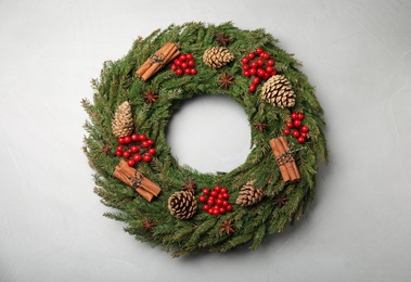 Beautiful Christmas wreath on light grey background, top view