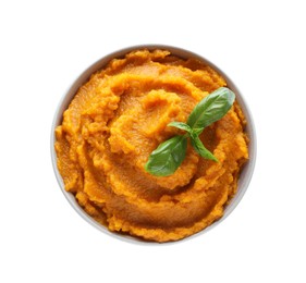 Photo of Delicious vegetable puree with basil in bowl isolated on white, top view. Healthy food