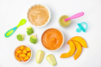 Flat lay composition with bowls of healthy baby food on white background