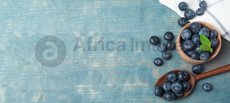 Tasty fresh blueberries on wooden table, flat lay with space for text. Banner design