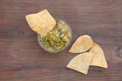 Photo of Tasty salsa sauce and tortilla chips on wooden table, flat lay