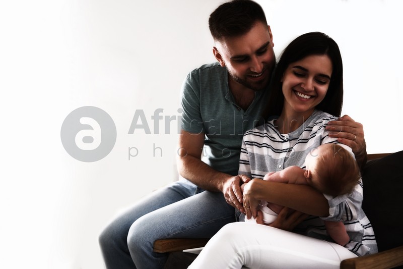 Happy family with their cute baby on white background