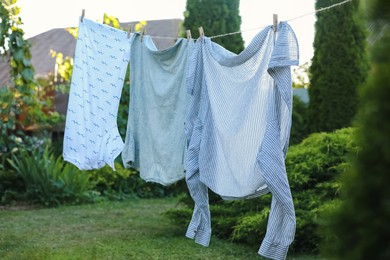 Shirts drying on washing line at backyard of house