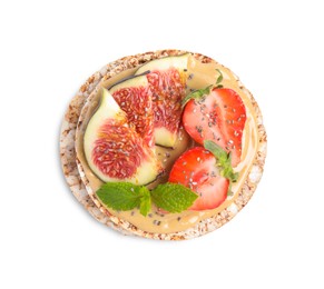 Photo of Tasty crispbreads with peanut butter, figs, mint and strawberry on white background, top view