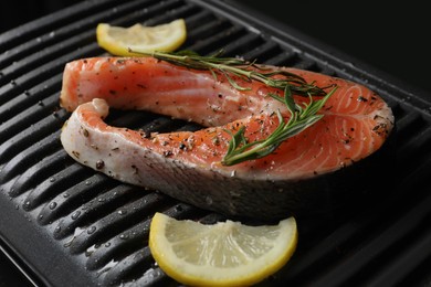Cooking salmon. Grill with fresh fish steak, lemon and rosemary