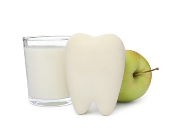 Tooth model, apple and milk on white background